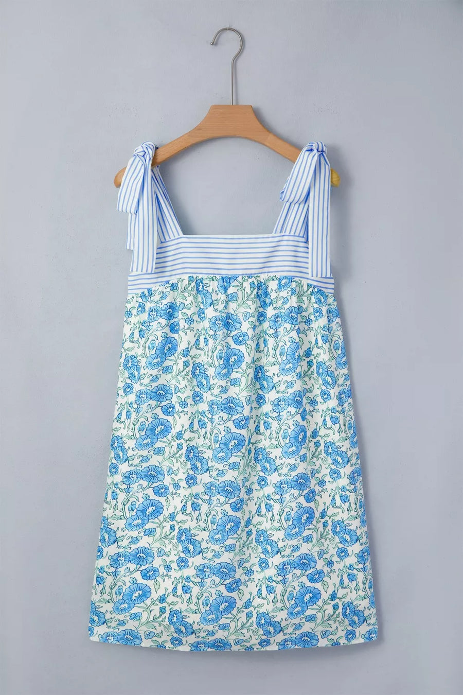 Botanical print mini dress with tie straps and blue stripe bodice detail.