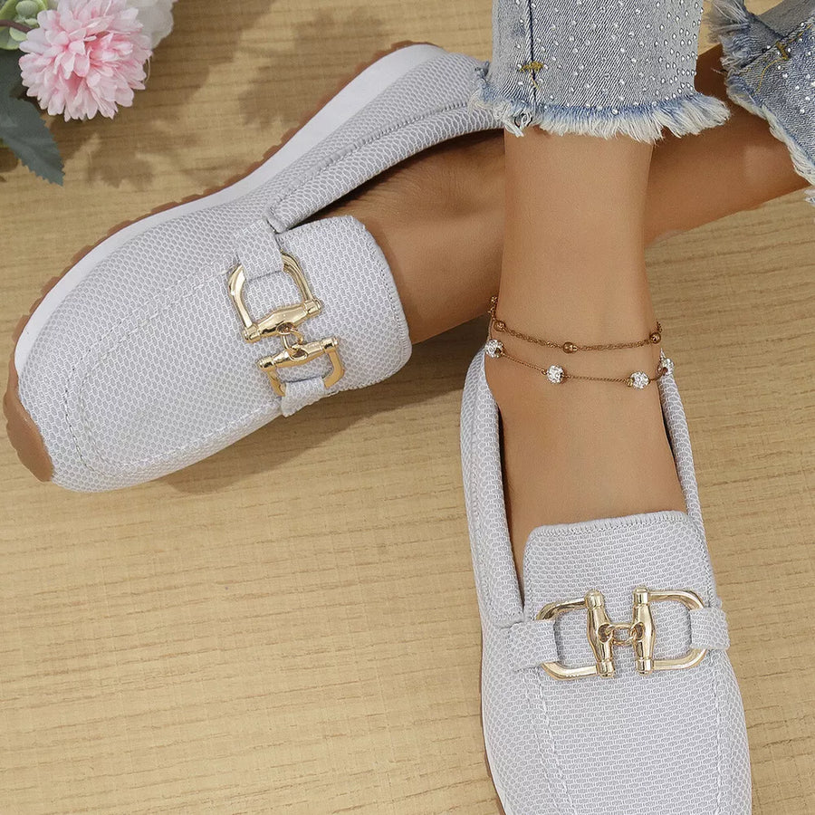 Chic mesh slip-on loafers in white with gold buckle detail.