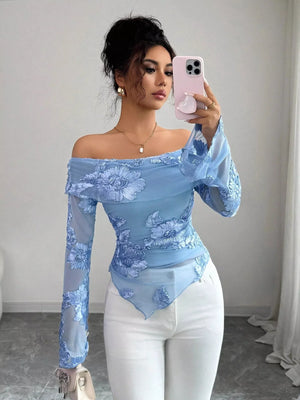 Floral ruffled off-shoulder blouse in sky blue with sheer sleeves and embroidered flowers.