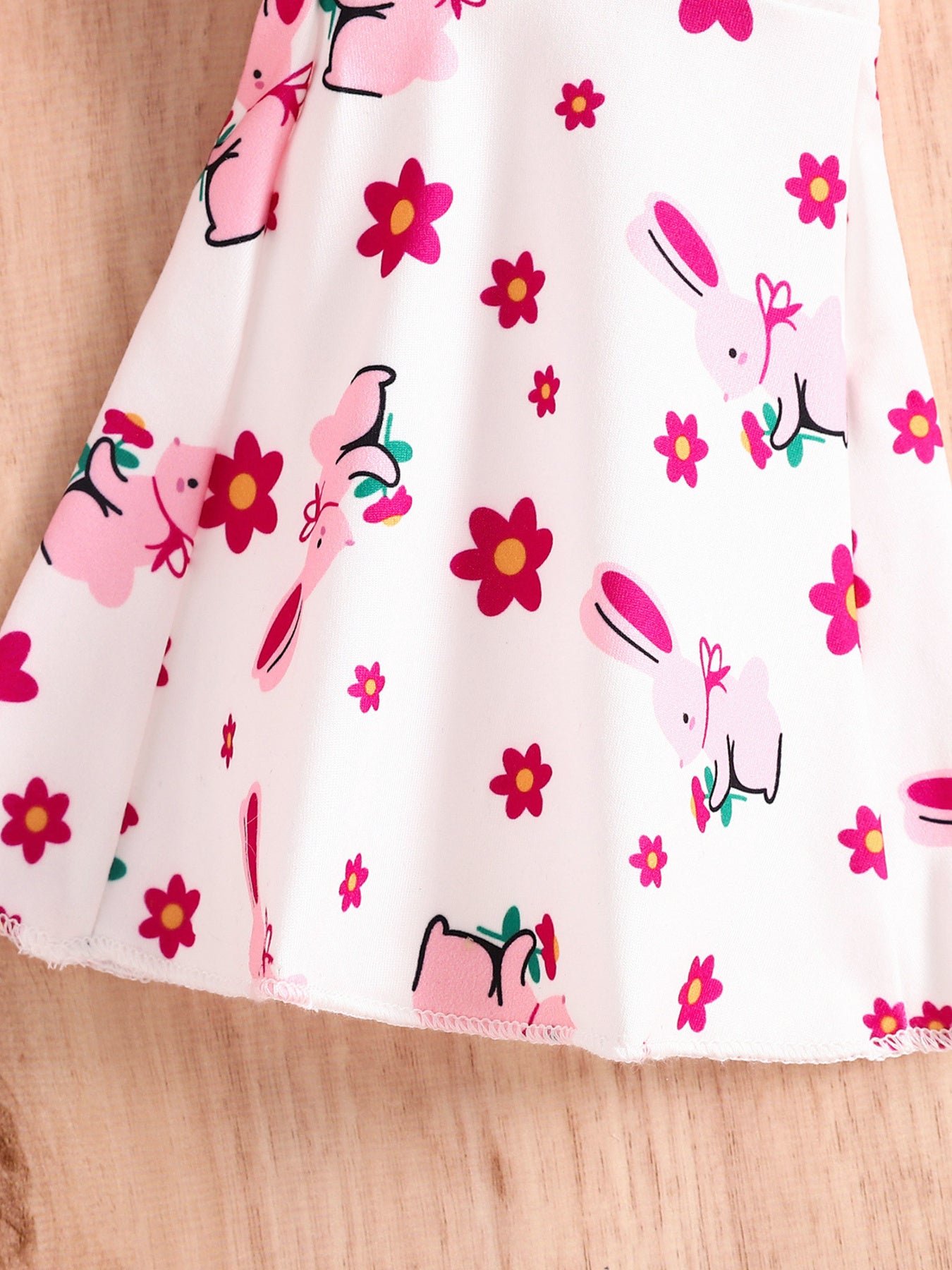 White cotton baby set with pink bunny and flower print.