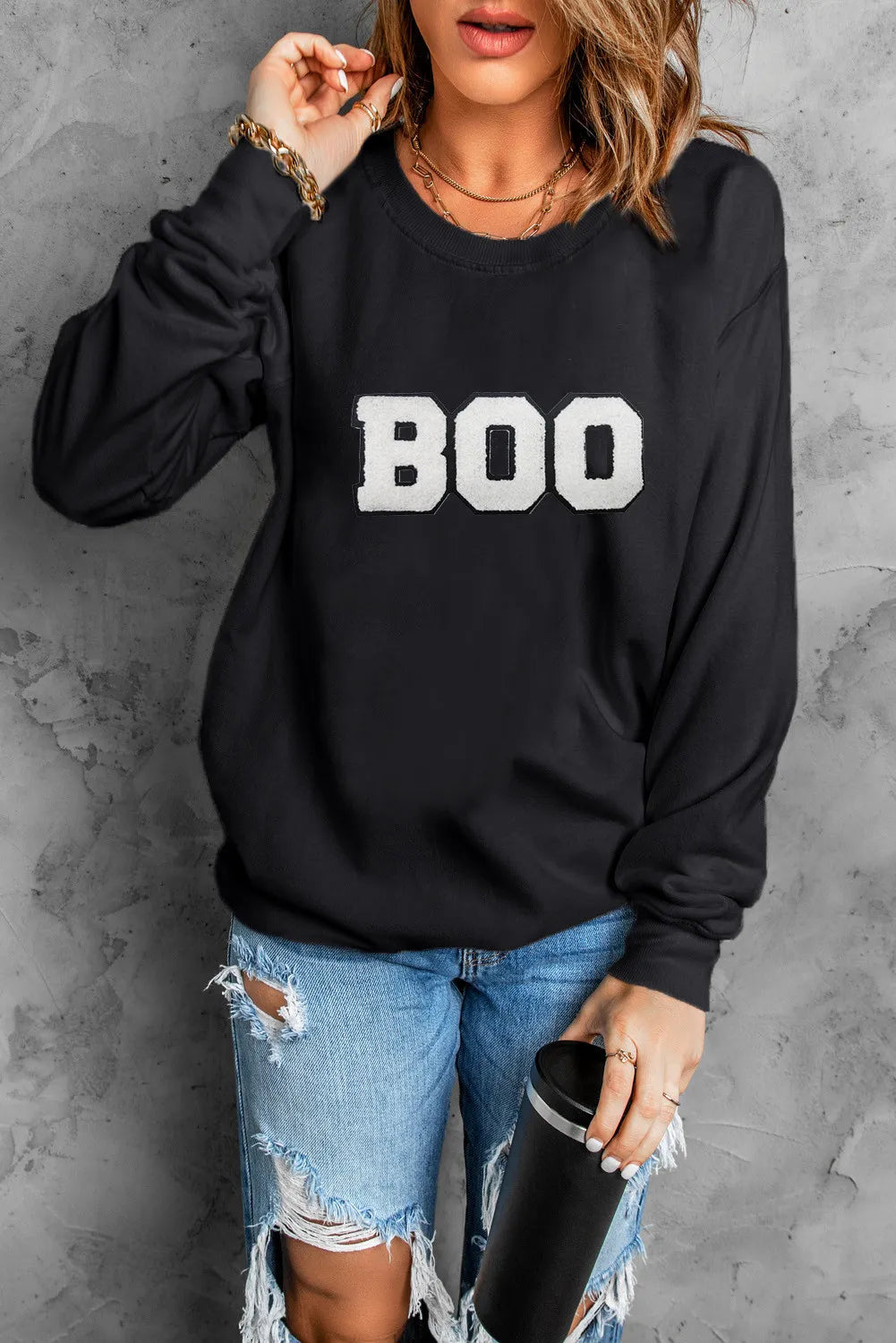 Black crewneck sweatshirt with white varsity "BOO" graphic