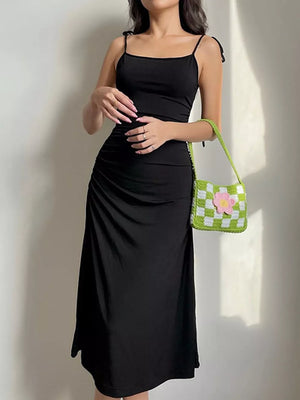 Black ruched midi dress with tie straps and a square neckline.