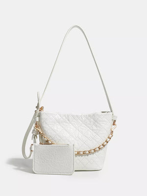 White quilted bucket bag with gold chain accent and matching card holder
