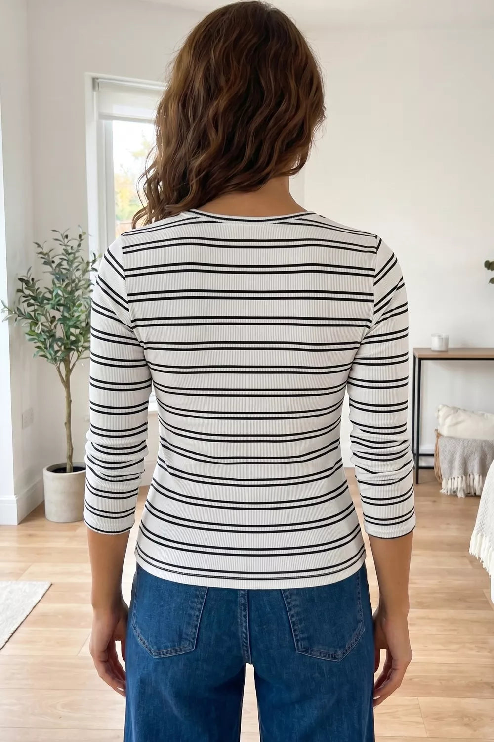 Striped knit top with 3/4 sleeves and a crew neck.