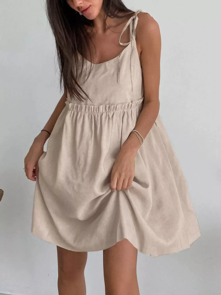 mini dress in light beige featuring tied straps and fit-and-flare fit