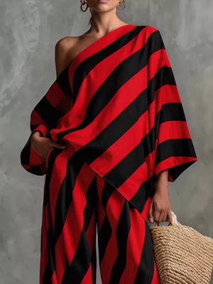 Red and black striped one-shoulder wide-leg jumpsuit with flowing sleeves