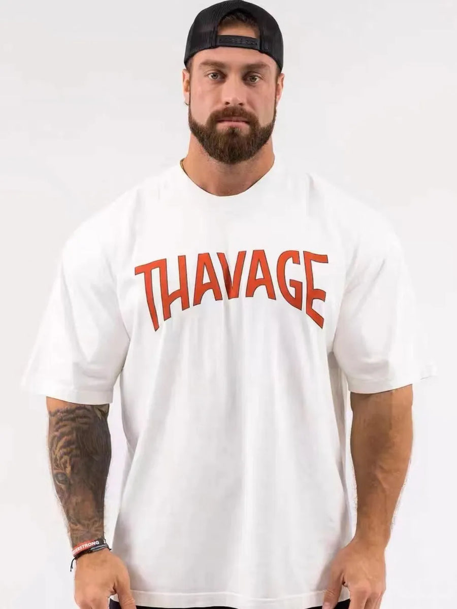 White oversized graphic tee with red THAVAGE print and short sleeves.