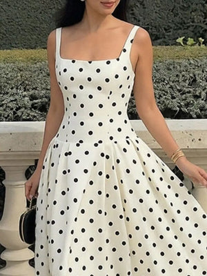 White A-line maxi dress with black polka dots, square neckline, and spaghetti straps.