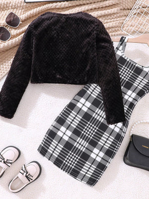 Black fuzzy cardigan with a plaid dress, a cozy outfit for babies.