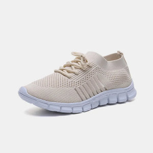 Beige knit runner sneakers with ribbed lace-up detail and white sole.