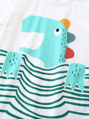 White cotton toddler tee with playful teal cartoon character and green stripes.