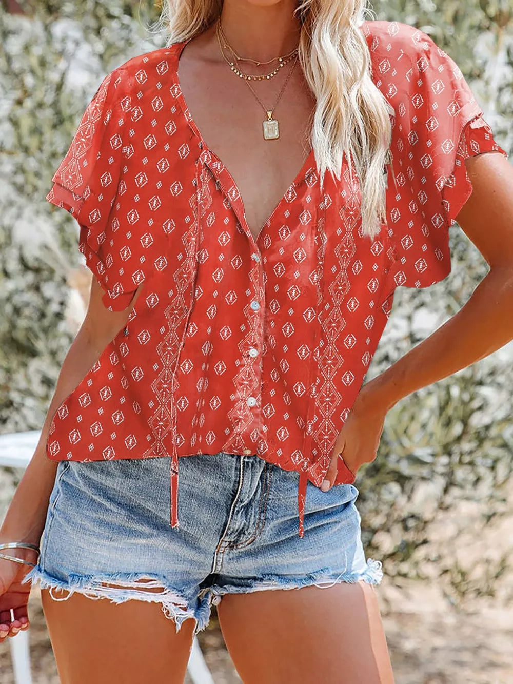 Red floral print v-neck blouse with tie detail and button front