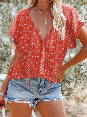 Red floral print v-neck blouse with tie detail and button front