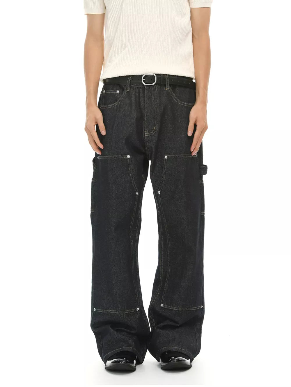 Dark wash cotton blend carpenter jeans with contrast stitching and distinctive pockets.