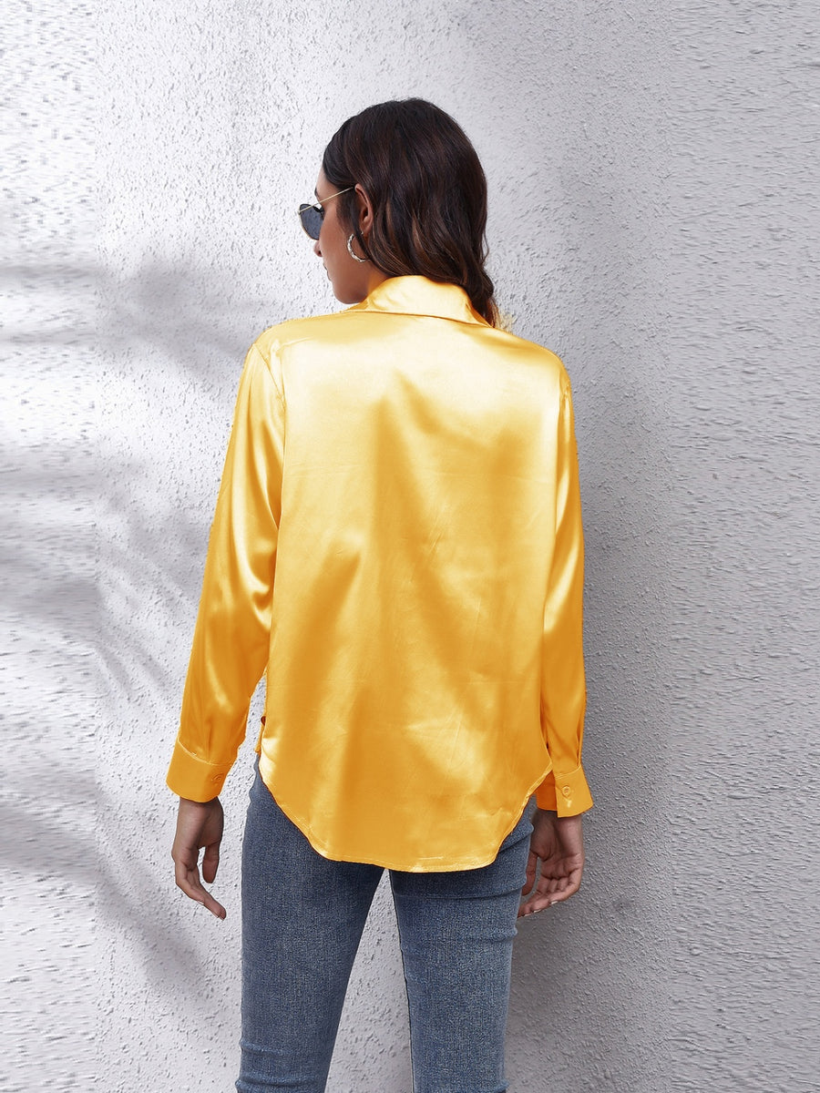 Gold silken button-down shirt with long sleeves and a relaxed fit.