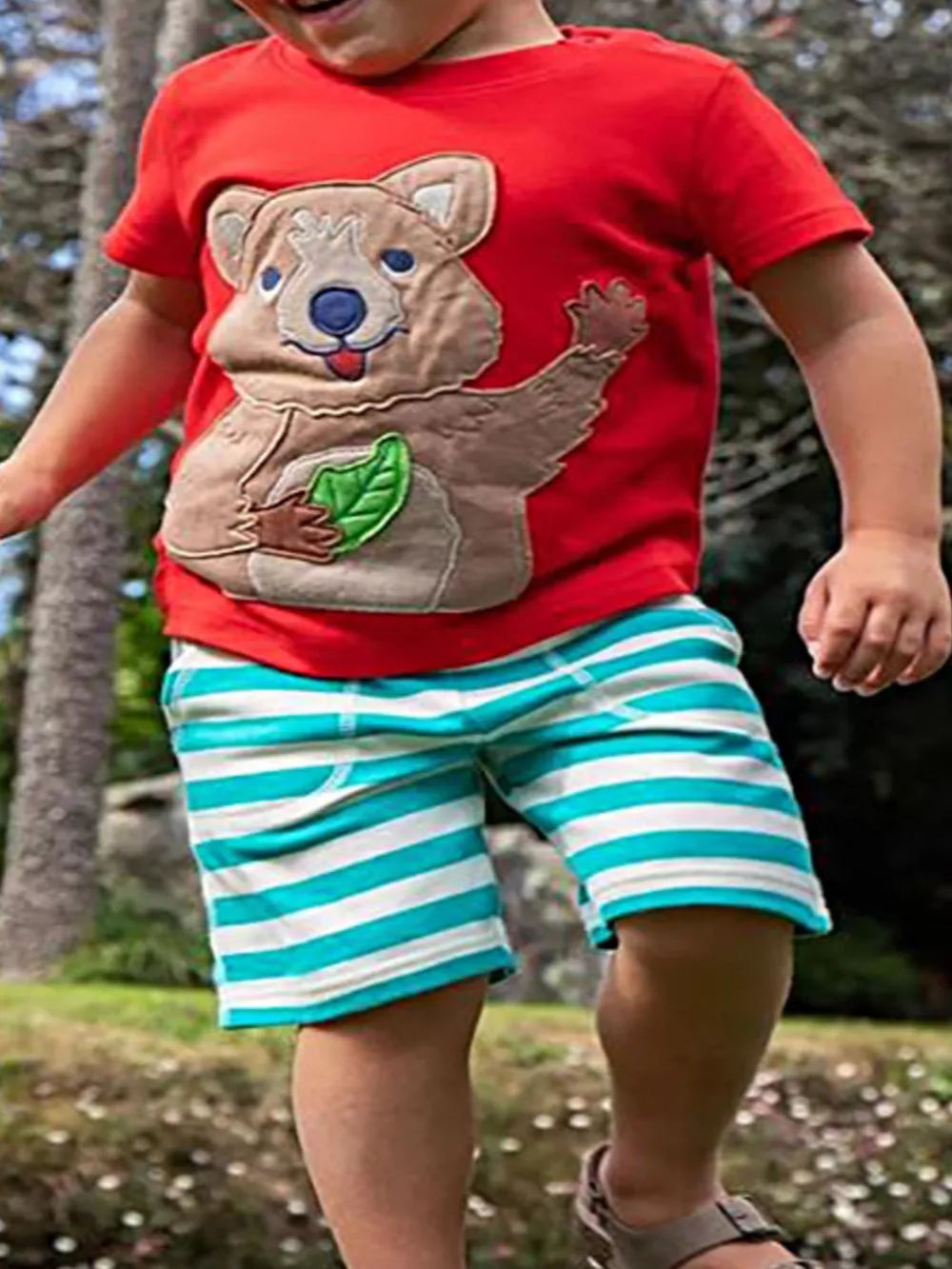 Toddler red t-shirt with cheerful quokka applique and striped shorts.