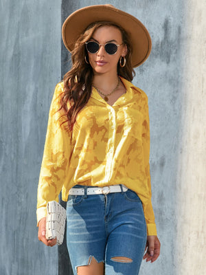 Yellow sheer floral embroidered button-down blouse with a collared neckline and long sleeves.
