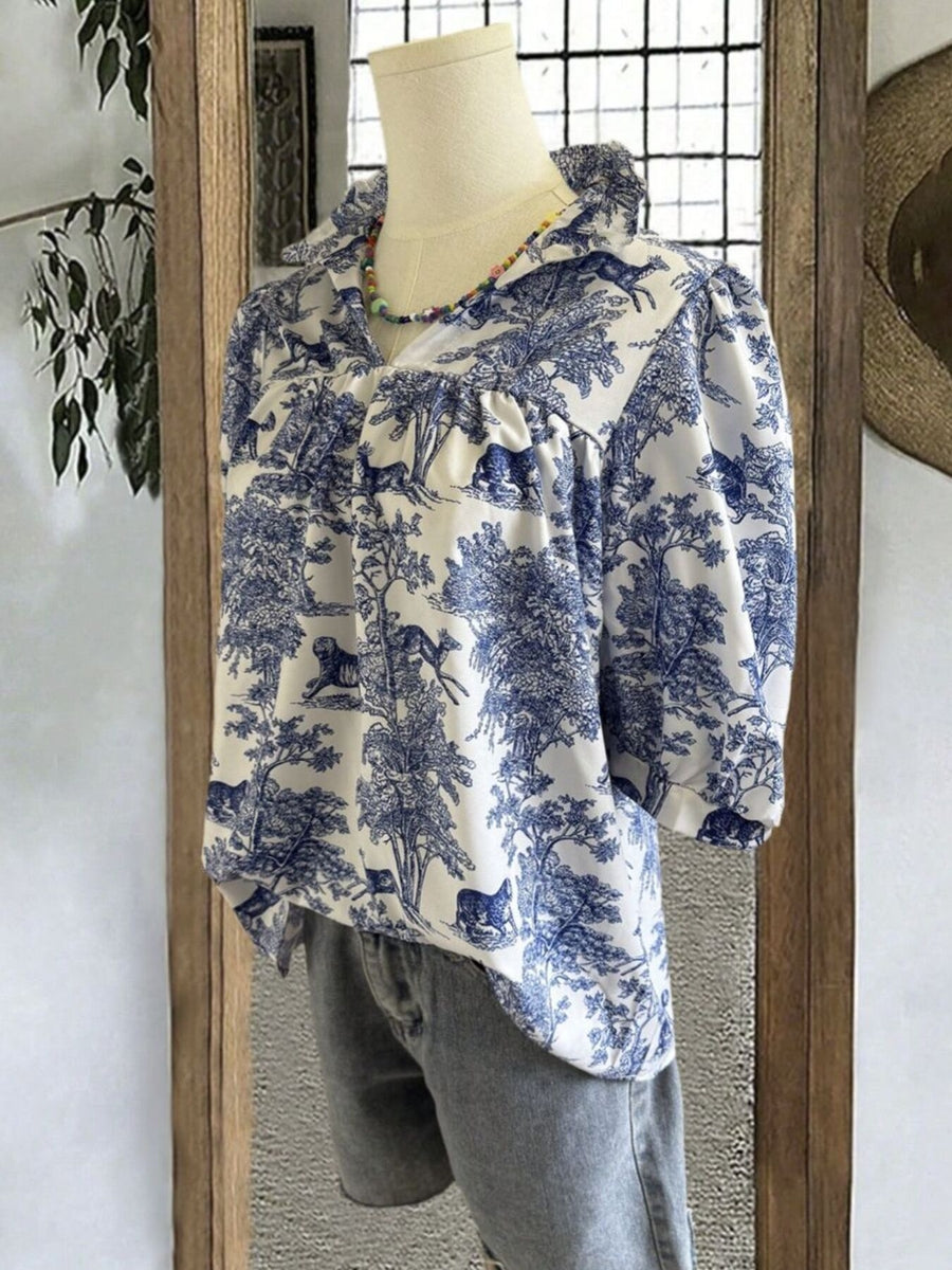 White and blue Toile De Jouy half sleeve blouse with a ruffled collar and gathered neckline.