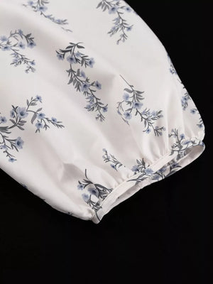 White puff sleeve top with blue floral print and gathered cuff