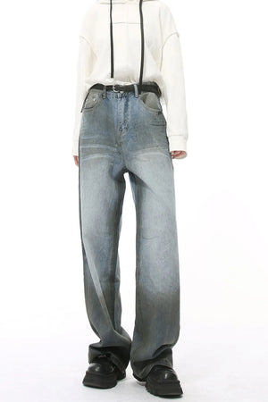 Pocketed high rise slouchy denim jeans in a medium wash with a dark gradient hem.
