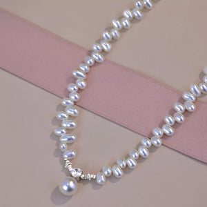 Lustrous irregular pearl pendant necklace with cubic zirconia accent.