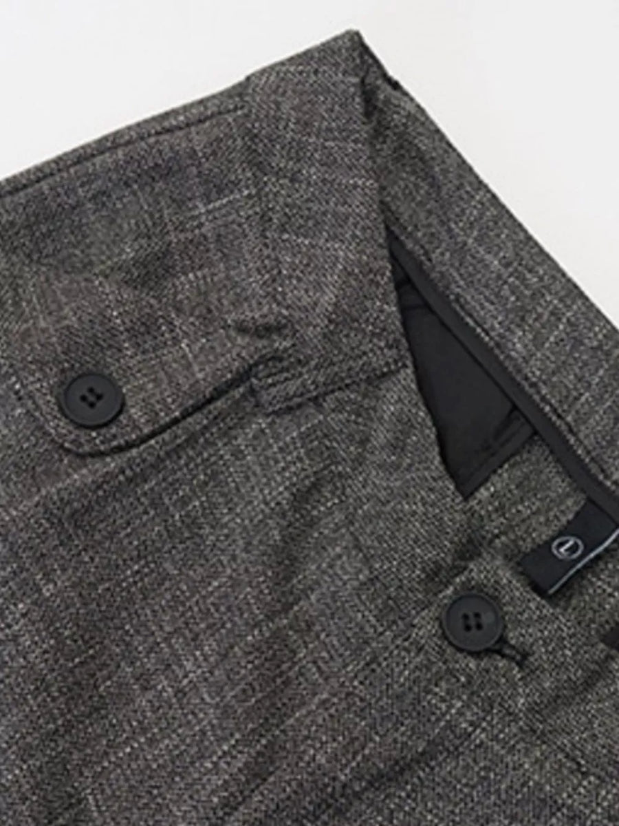 Textured dark gray sweatpants with button flap pocket and button closure.