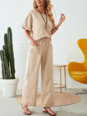 Tan linen co-ord set with wide leg pants and a relaxed fit top.