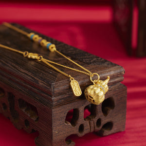 Gold necklace featuring gourd pendant and geometric