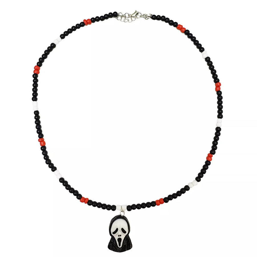 necklace in white with character-motif and beaded