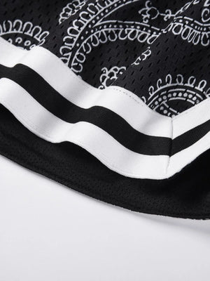 Black mesh basketball shorts with white paisley pattern and striped trim