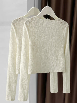 Lace button-up cardigan in cream with delicate textured pattern and long sleeves.