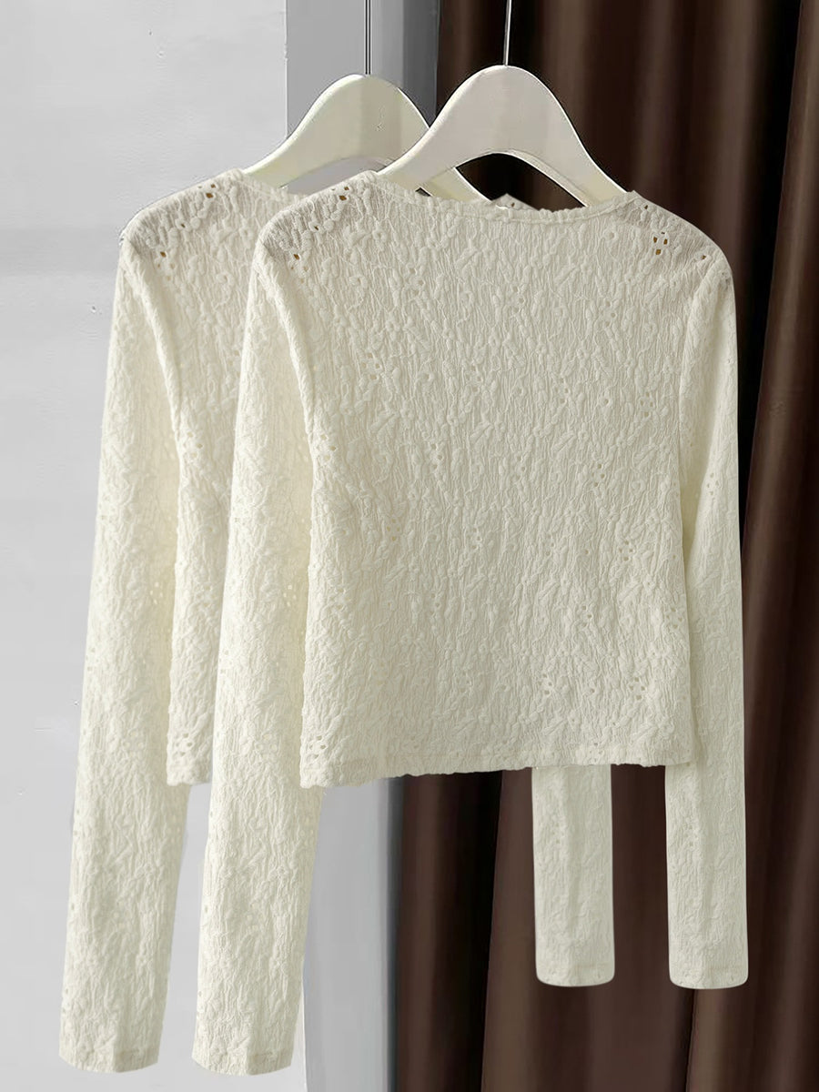 Lace button-up cardigan in cream with delicate textured pattern and long sleeves.