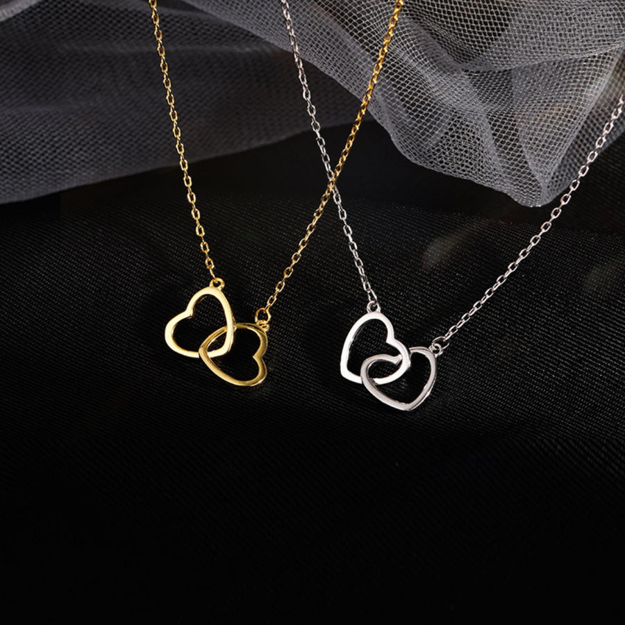 Interlocking heart pendant necklaces in gold and silver, delicate jewelry for women.