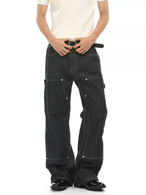 Dark wash cotton blend carpenter jeans with contrast stitching and distinctive pockets.