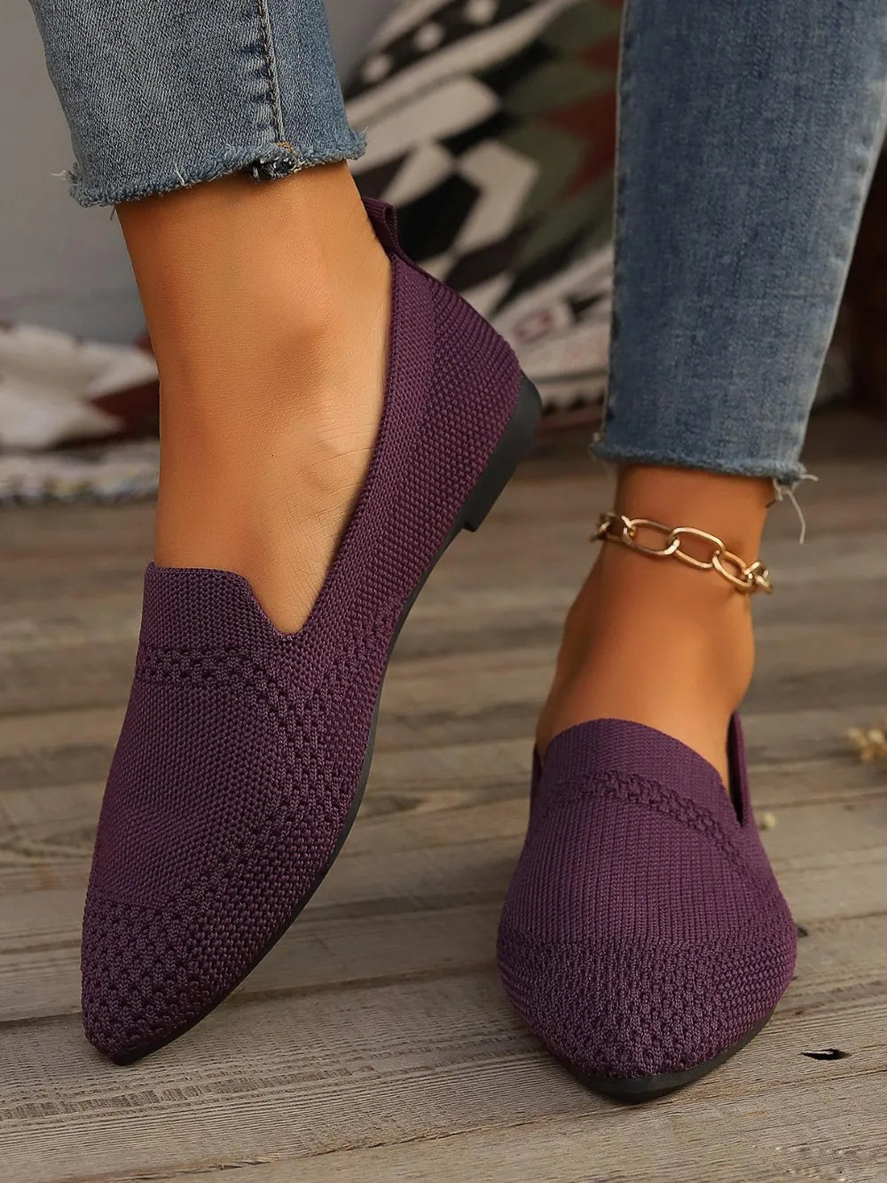 Plum purple mesh point flats with a textured knit pattern.
