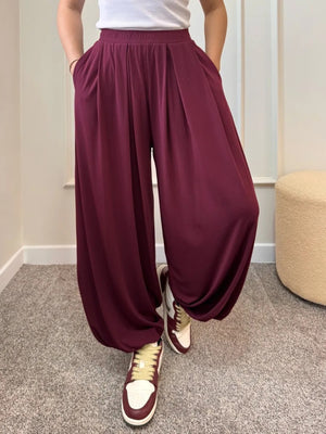 100% polyester Care instructions: Machine wash cold wide-leg pants in Black with loose silhouette