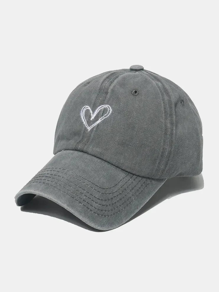 Gray washed cotton baseball cap with embroidered white heart detail.