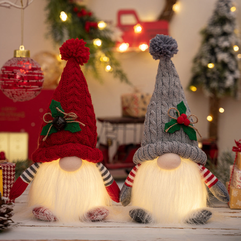 Illuminated knit gnomes in deep red and light gray with pom-pom hats and festive accents.