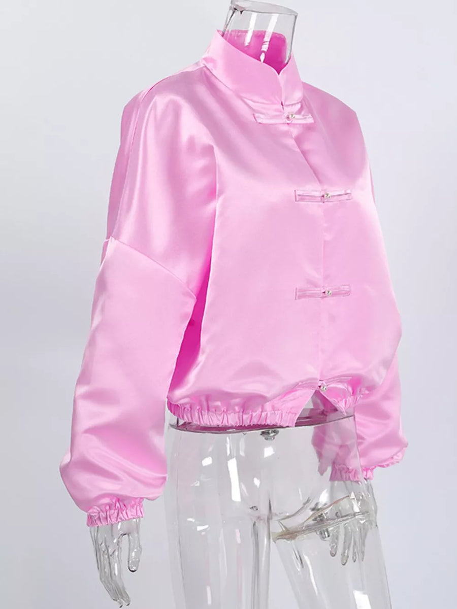 pink button-up shirt with decorative button and bishop sleeve