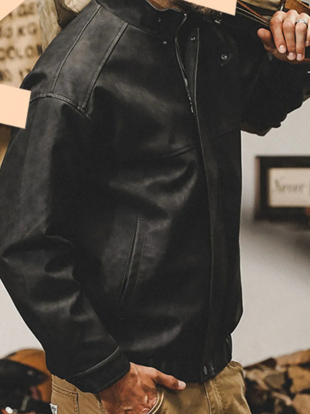 Black distressed leather bomber jacket with stand collar and zip closure