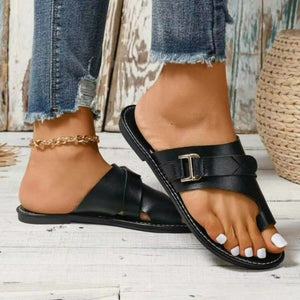 Black toe ring sandals with buckle detail and criss-cross straps.
