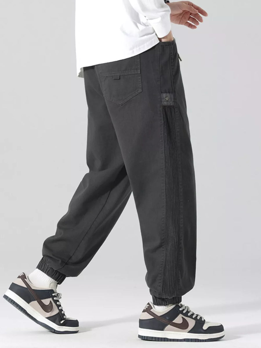 Oversized grey cargo joggers with drawstring and ribbed side detail.