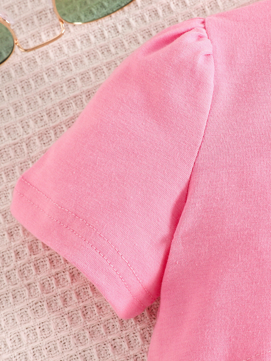 Pink toddler crop top with puff sleeves made of cotton blend.