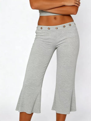 Light gray flared hem capri pants with button detail at the waist