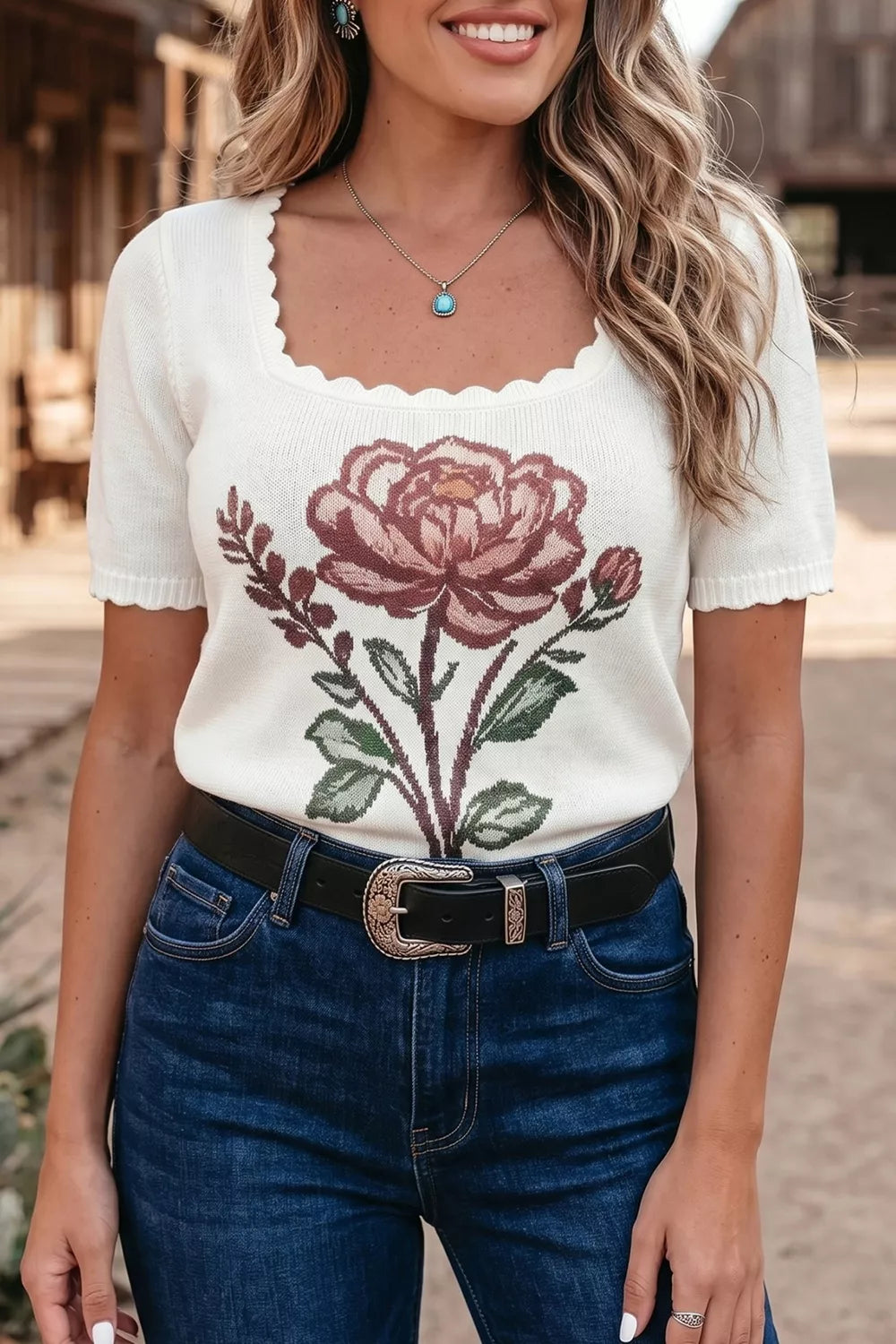 White knit short sleeve top with scalloped neckline and floral embroidery