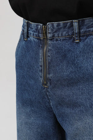 Zip-front relaxed denim trousers in medium wash, featuring a metal zipper closure and belt loops.