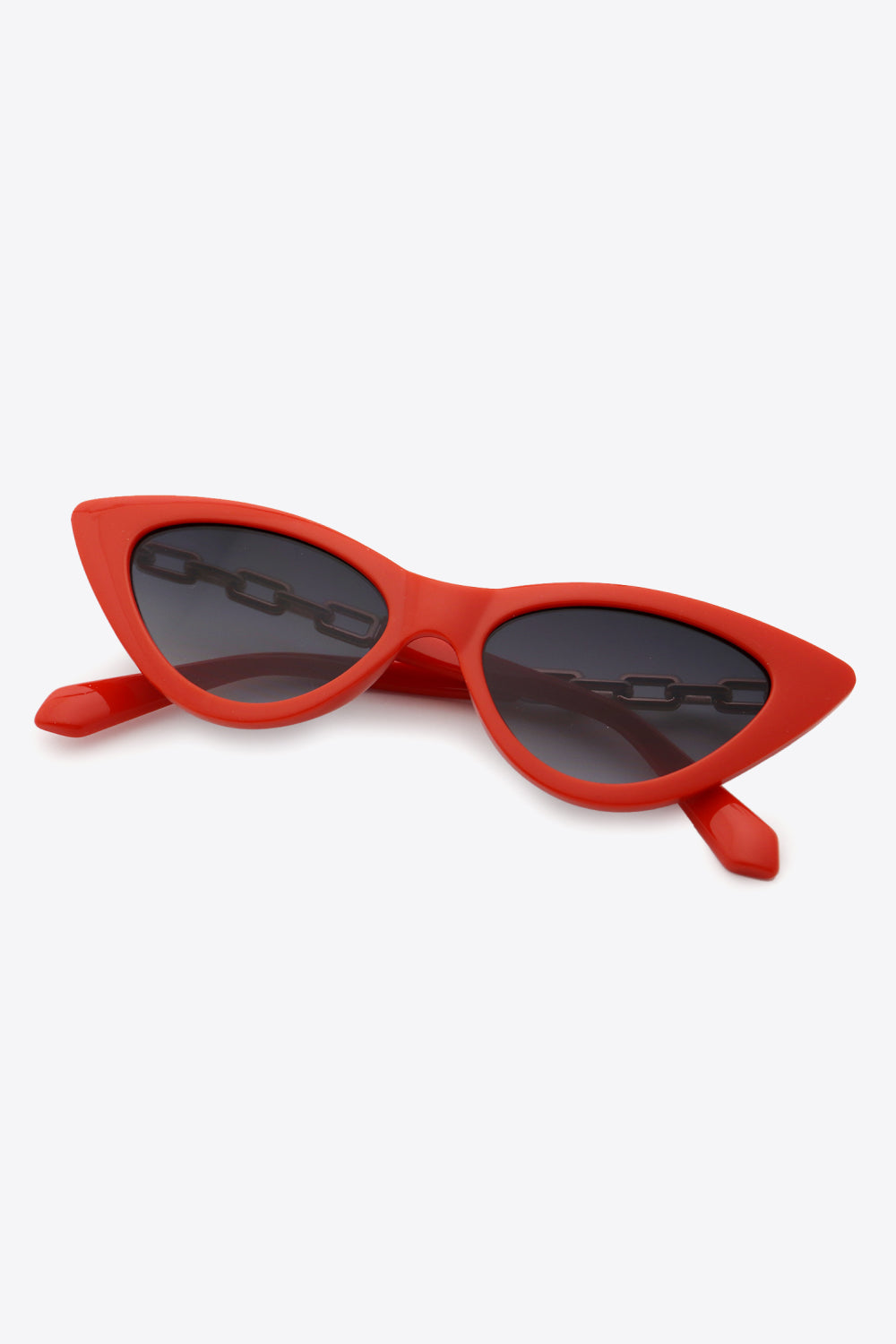 Chainlink cat-eye sunglasses in deep red with a chain detail across the lenses.