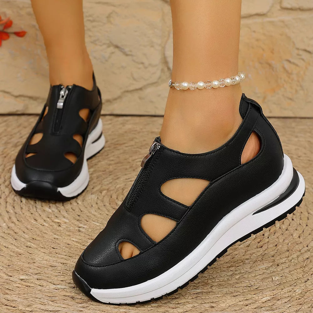 Black cutout wedge sneakers with zipper and chunky white sole