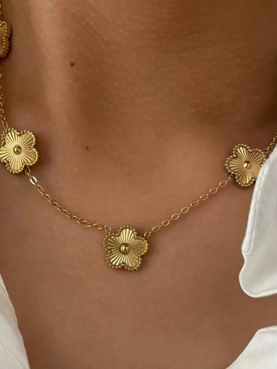 Gold necklace featuring delicate floral charms and floral