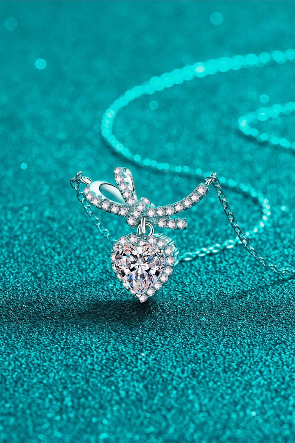 Silver cubic zirconia bow accent heart necklace with a delicate chain.